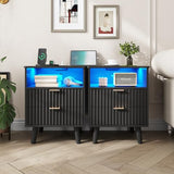 AOGLLATI Fluted Nightstand Set of 2 with Charging Station, Black LED Nightstand with 2 Drawers and Open Storage Cubby, Modern Bedside Table with LED Lights & Metal Handle for Bedroom