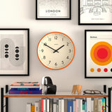 JONES CLOCKS® Studio wall Clock | Modern Round Style | 12 inch | Orange | Easy to Read Numbers | Versatile Design for Kitchen, Living Room or Office