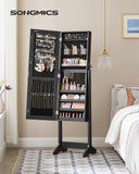 SONGMICS Jewelry Cabinet Armoire, Freestanding Lockable Storage Organizer Unit with 2 Plastic Cosmetic Storage, Full-Length Frameless Mirror, for Necklace Earring, Black UJJC002B01